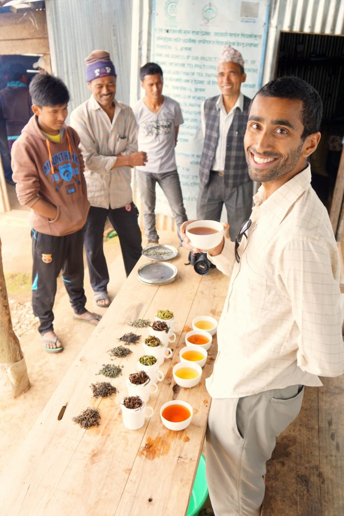 Raj with customers at a tea cupping.