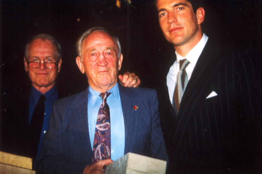 Paul Newman and John F. Kennedy Jr. presenting the Most Generous Company in the US award to Hal Taussig of UnTours