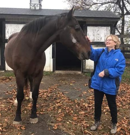 PHOTO:  FREe-CARRIAGES' Janet White visiting a former Philadelphia carriage horse, Mark, who is now living out the rest of his days at Equine Advocates Sanctuary in Chatham, NY. 
